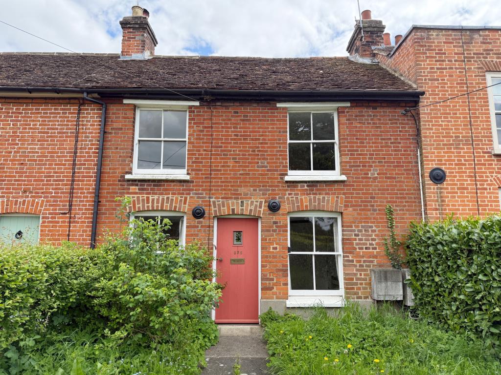 Lot: 165 - MID-TERRACE COTTAGE FOR IMPROVEMENT - front elevation of the cottage on Roman Road Mountnessing